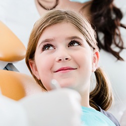 Smiling young girl in dental chair