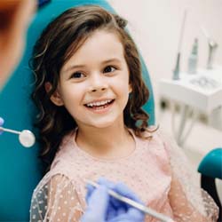 young girl smiling while visiting pediatric dentist in Casper