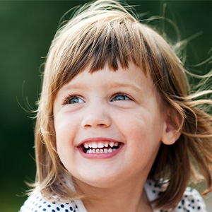 Little girl with healthy smile after dental sealant treatment