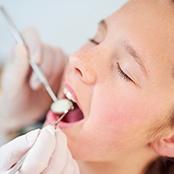 Child receiving silver diamine fluoride treatment