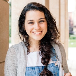 A female teenager wearing overalls smiles after undergoing a regular dental checkup in Casper