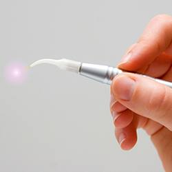 Hand holding a soft tissue laser