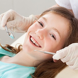 Smiling young girl in dental chair