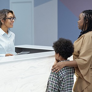 Woman and son with a receptionist