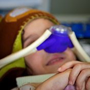 Child in dental chair with nitrous oxide nasal mask