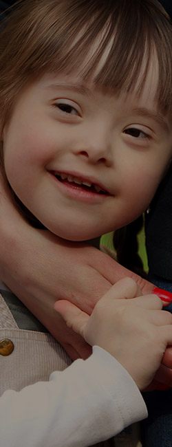 Child with special needs holding hands with their mother