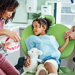 Dental team member talking to child about oral health