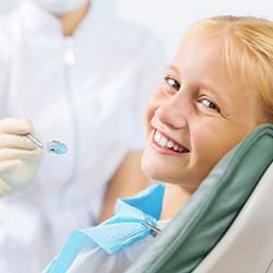 Dentist performing oral cancer screening in Casper