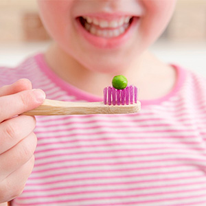 Three happy kids with healthy smiles after dental sealants