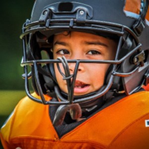 Child in black and orange football attire