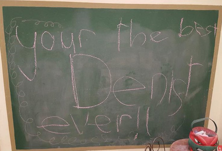 Note from child on chalkboard for best dentist ever