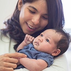 Mother holding happy baby