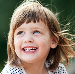 Little girl smiling outdoors