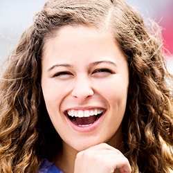 Laughing young woman outside