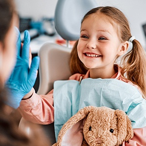 Young girl smiling at the dentist 