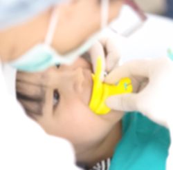 Child receiving fluoride treatment