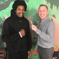 Dentist posing with athlete wearing custom mouthguard