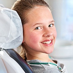 Smiling girl in dental chair