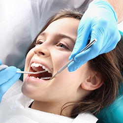 Young girl receiving dental exam