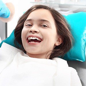 Smiling girl in dental chair