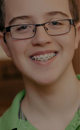 Preteen boy with traditional braces