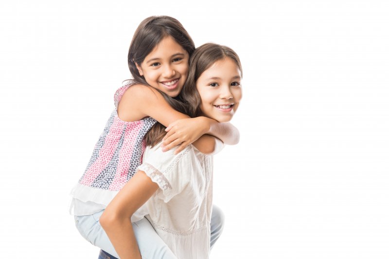 two young girls smiling after receiving dental sealants in Casper