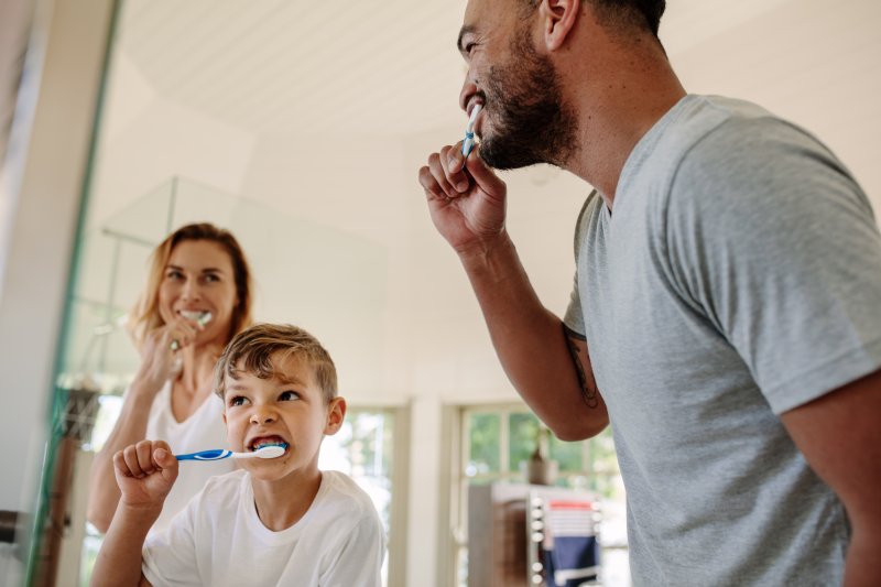 Family Brushing Teeth Together in Their Bathroom