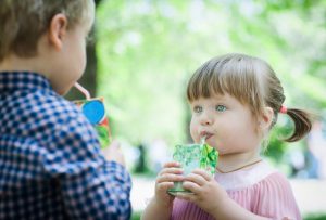 child drinking juice box 