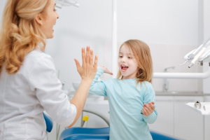 child visiting her dentist