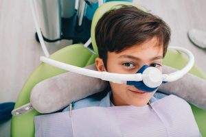 Young dental patient wearing nitrous oxide mask