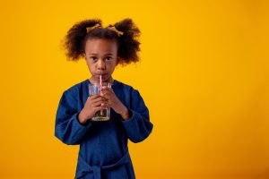 Young girl drinking apple juice