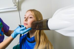 Young girl getting dental X-ray taken